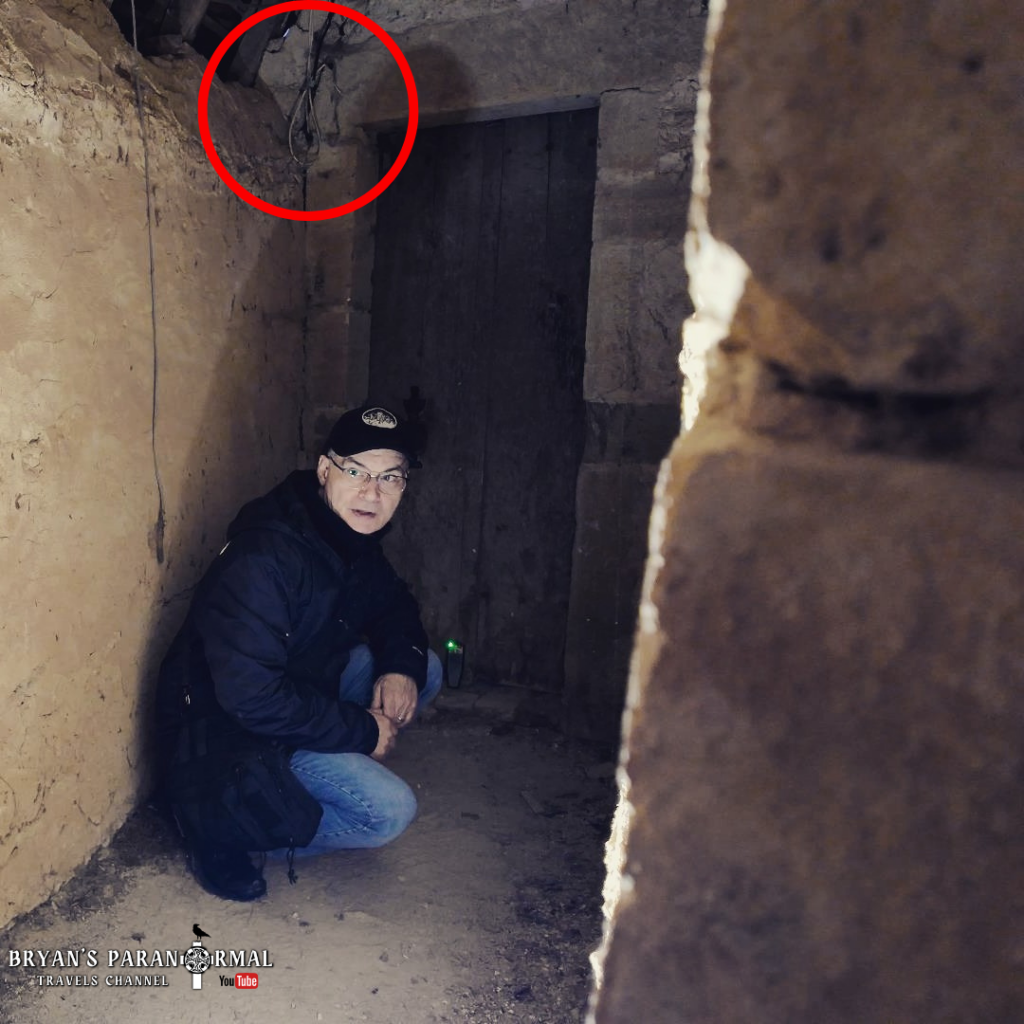 Hangman’s noose above the dungeon doorway at Château de Veauce, linked to reported shadow figure sightings 